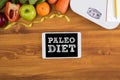 PALEO DIET ( Fitness and weight loss concept, fruit and tape measure on a wooden table, top view) Royalty Free Stock Photo