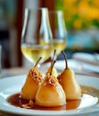 Paleo style dessert poached pear dessert pashot. Pear caramelized in syrup on a wooden plate