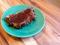 Paleo, vegan seedy bread topped with marmite, on green plate