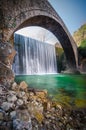 Paleokarya old stone arched bridge between two waterfalls. Trikala prefecture, Greece Royalty Free Stock Photo