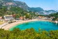 Paleokastritsa beach and village on Corfu island, Greece. Picturesque seashore with turquoise crystal water, pebble Royalty Free Stock Photo