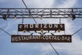 Paleokastritsa, Cofru, Greece- MAY 10, 2018 Hanging welcome signage of Horizon Restaurant Cocktail Bar. The wooden post with metal