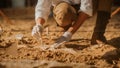 Paleontologist Cleaning Tyrannosaurus Dinosaur Skeleton with Brushes. Archeologists Discover Fossil Royalty Free Stock Photo