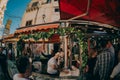 Local citizens and toursits on a street market on a weekend day. Merchants selling dried bowels