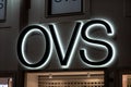 The logo of the Oviesse OVS fashion store at night which sells clothing