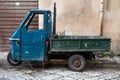 Palermo, Sicily, Italy - An old Piaggio Ape truck against a traditional faacde Royalty Free Stock Photo