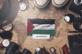 Palestine Flag Between Traveler`s Accessories on Old Vintage Map. Overhead Shot