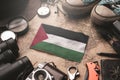 Palestine Flag Between Traveler`s Accessories on Old Vintage Map. Tourist Destination Concept