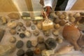 Palestinian cleans artifacts at the museum, while the Ministry of Tourism announced the closure of tourist places due to the outbr