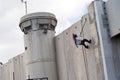 Palestinian climbs Israeli separation wall Royalty Free Stock Photo