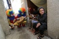 Palestinian clown wears a protective face mask while entertaining children staying at their home due a precautionary measure again Royalty Free Stock Photo