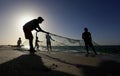 Palestinian fishermen gather their nets at the beach