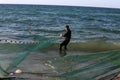 Palestinian fishermen gather their nets at the beach