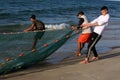 Palestinian fishermen gather their nets at the beach