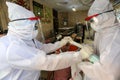 Palestinian medical workers take a random swab samples to check the Coronavirus Covid-19, from a shop owners