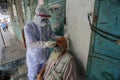 Palestinian medical workers take a random swab samples to check the Coronavirus Covid-19, from a shop owners