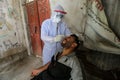 Palestinian medical workers take a random swab samples to check the Coronavirus Covid-19, from a shop owners