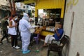 Palestinian medical workers take a random swab samples to check the Coronavirus Covid-19, from a shop owners