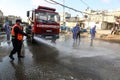 Palestinian municipality and civil defense employees organize a street cleaning and sterilization campaign in light of the coronav