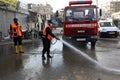 Palestinian municipality and civil defense employees organize a street cleaning and sterilization campaign in light of the coronav