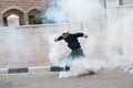 Palestinian throws back tear gas