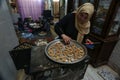 Palestinian women prepare traditional cookies ahead of the Eid al-Fitr festivities