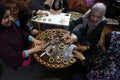 Palestinian women prepare traditional cookies ahead of the Eid al-Fitr festivities