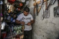 Palestinian worker sharpens a knife that will be used to slaughter cattle during the Muslim festival of sacrifice Eid al-Adha