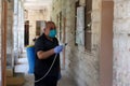 A Palestinian worker wearing a protective face mask sanitises a classroom in school a before a new academic year starts, amid conc