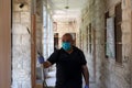 A Palestinian worker wearing a protective face mask sanitises a classroom in school a before a new academic year starts, amid conc