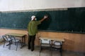 A Palestinian worker wearing a protective face mask sanitises a classroom in school a before a new academic year starts, amid conc