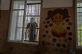 A Palestinian worker wearing a protective face mask sanitises a classroom in school a before a new academic year starts, amid conc