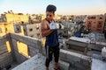 Palestinian youths playing bodybuilding on the roof of their house because clubs are closed, during a of the outbreak of the Coron