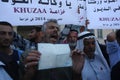 Palestinians attend a protest demanding UNRWA to pay Palestinian families for the repair of their homes, damaged during the 2014 I