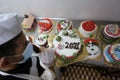 Palestinians chef create New Year and Christmas-styled festive cakes at a bakery