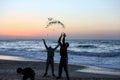 Palestinians enjoy themselves on the beach during sunset, in Gaza Strip