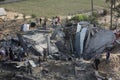 Palestinians gather around the remains of a house destroyed in an Israeli air strike in Khan Younis