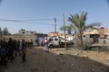 Palestinians gather around the remains of a house destroyed in an Israeli air strike