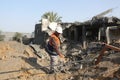 Palestinians gather around the remains of a house destroyed in an Israeli air strike