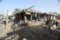 Palestinians gather around the remains of a house destroyed in an Israeli air strike