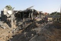 Palestinians gather around the remains of a house destroyed in an Israeli air strike