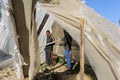 Palestinians inspect the damage at the site of an Israeli air strike