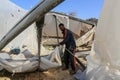 Palestinians inspect the damage at the site of an Israeli air strike