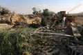 Palestinians inspect the damage at the site of an Israeli air strike