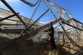 Palestinians inspect the damage at the site of an Israeli air strike