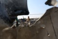 Palestinians inspect a seaport after an Israeli airstrike in the southern Gaza Strip
