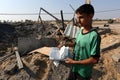 Palestinians inspect a seaport after an Israeli airstrike in the southern Gaza Strip