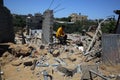 Palestinians inspect their destroyed houses by recent Israeli air strikes in the Gaza Strip