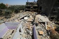 Palestinians inspect their destroyed houses by recent Israeli air strikes in the Gaza Strip