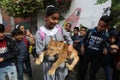 Palestinians plays with a lion cub on the streets of the refugee camp